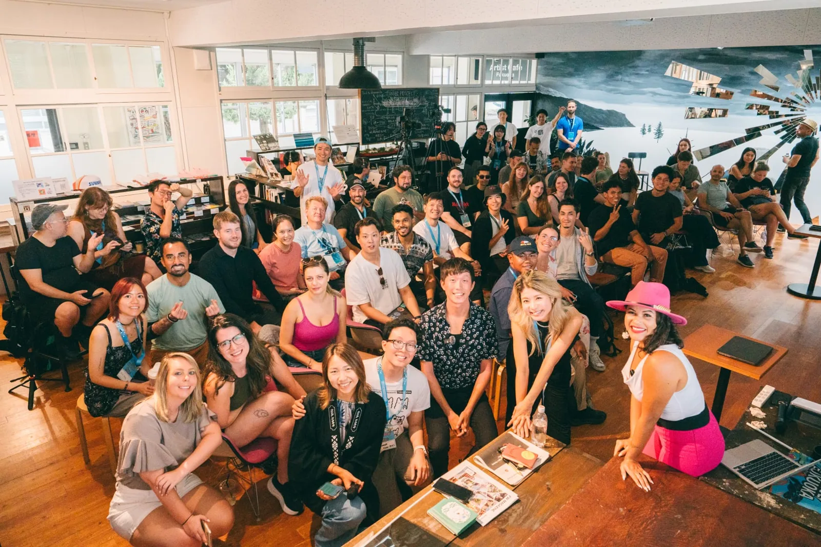 Large group of Colive Fukuoka participants gathered together in an open creative studio space in Fukuoka, Japan.