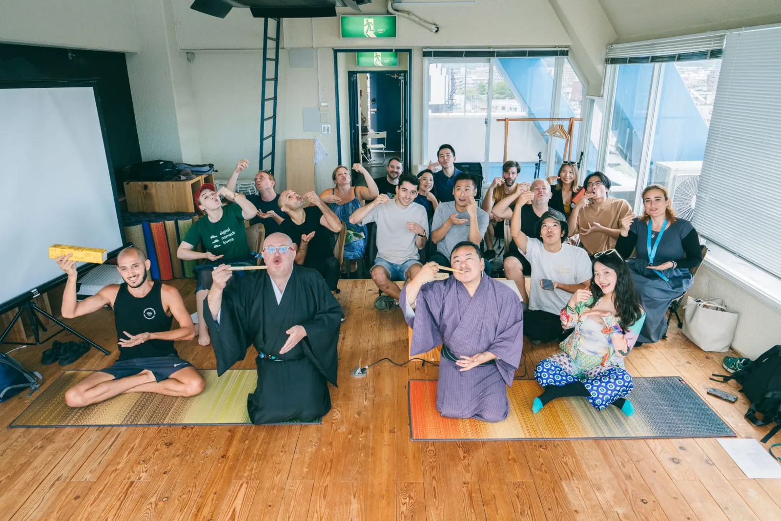 Group photo of Colive Fukuoka attendees making a playful gesture together after a session.